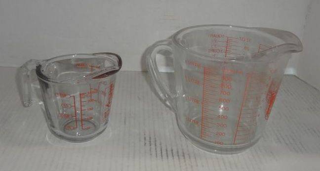 Sold at Auction: Large Tupperware Measuring cup, with lid