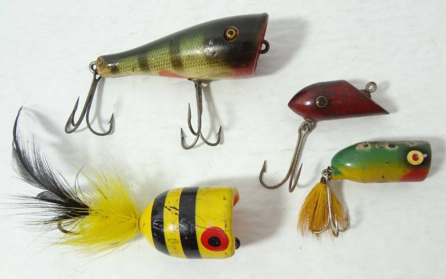 Four Vintage Wood Fishing Lures, Glass Eyes Heddon Plunker 3, 1 3/4  Yellow Black Top Water Lure, 1 1/4 Top Water Frog Pattern Lure and 1 3/4  Bite Em Wood Lure, All